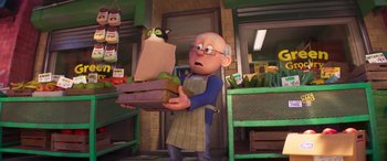 Movie still from “The Super Mario Bros. Movie” (2023), directed by Aaron Horvath – An old man holding a box of fruit in a store; Medium shot, Over the shoulder angle