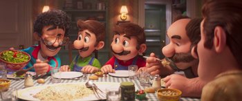 Movie still from “The Super Mario Bros. Movie” (2023), directed by Aaron Horvath – A group of people sitting at a table eating food; Medium shot, Over the shoulder angle