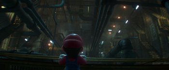 Movie still from “The Super Mario Bros. Movie” (2023), directed by Aaron Horvath – A red and blue figurine sitting on top of a rail; Medium shot, Over the shoulder angle