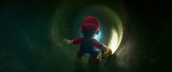 Movie still from “The Super Mario Bros. Movie” (2023), directed by Aaron Horvath – A statue of a man holding a banana in a tunnel; Medium shot, Low angle