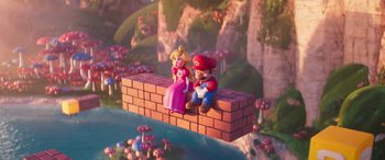Movie still from “The Super Mario Bros. Movie” (2023), directed by Aaron Horvath – A couple of figurines sitting on top of a brick wall; Wide shot, Over the shoulder angle