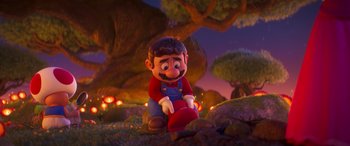 Movie still from “The Super Mario Bros. Movie” (2023), directed by Aaron Horvath – A cartoon character sitting on the ground in a forest; Medium shot, Over the shoulder angle
