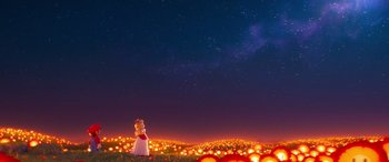 Movie still from “The Super Mario Bros. Movie” (2023), directed by Aaron Horvath – A woman standing in a field at night with lights in the background; Extreme Wide shot, Low angle