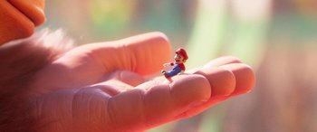 Movie still from “The Super Mario Bros. Movie” (2023), directed by Aaron Horvath – A small figurine of mario sitting on top of a persons hand; Extreme Close Up shot, High angle