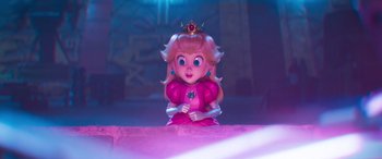 Movie still from “The Super Mario Bros. Movie” (2023), directed by Aaron Horvath – A pink princess doll sitting on top of a table; Medium shot, High angle