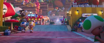 Movie still from “The Super Mario Bros. Movie” (2023), directed by Aaron Horvath – A street scene of a town with a bunch of balloons; Extreme Wide shot, High angle