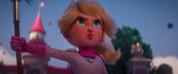 Movie still from “The Super Mario Bros. Movie” (2023), directed by Aaron Horvath – A doll's face with a pink shirt; Medium shot, Low angle