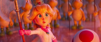 Movie still from “The Super Mario Bros. Movie” (2023), directed by Aaron Horvath – A toy doll with a crown on it's head; Close Up shot, Over the shoulder angle