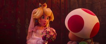 Movie still from “The Super Mario Bros. Movie” (2023), directed by Aaron Horvath – A princess peach doll holding a bouquet of flowers; Close Up shot, Over the shoulder angle