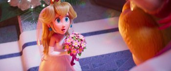 Movie still from “The Super Mario Bros. Movie” (2023), directed by Aaron Horvath – A figurine of a princess holding a bouquet of flowers; Close Up shot, Over the shoulder angle
