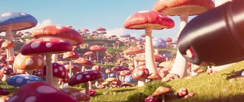 Movie still from “The Super Mario Bros. Movie” (2023), directed by Aaron Horvath – A bunch of mushrooms that are in the grass; Extreme Wide shot, High angle