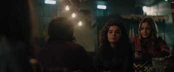 Movie still from “The Swimmers” (2022), directed by Sally El Hosaini – A woman sitting in front of a man in front of a mirror; Close Up shot, Over the shoulder angle
