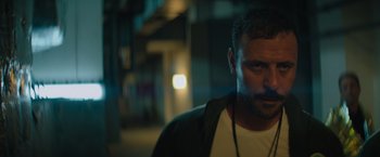 Movie still from “The Swimmers” (2022), directed by Sally El Hosaini – A person wearing a jacket; Close Up shot, Low angle