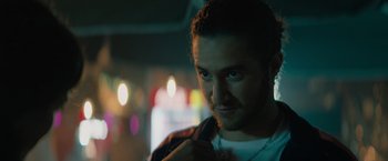 Movie still from “The Swimmers” (2022), directed by Sally El Hosaini – A person wearing a white t - shirt; Close Up shot, Over the shoulder angle