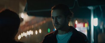 Movie still from “The Swimmers” (2022), directed by Sally El Hosaini – A man with a beard is standing in the dark; Close Up shot, Low angle