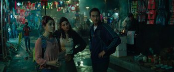 Movie still from “The Swimmers” (2022), directed by Sally El Hosaini – A group of young people standing in a room; Medium shot, Low angle