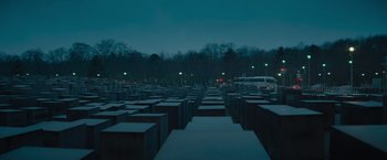 Movie still from “The Swimmers” (2022), directed by Sally El Hosaini – A group of concrete cubes in the middle of a field; Extreme Wide shot, High angle