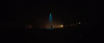 Movie still from “The Swimmers” (2022), directed by Sally El Hosaini – Two people standing in the middle of a field at night; Extreme Wide shot, Low angle