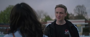 Movie still from “The Swimmers” (2022), directed by Sally El Hosaini – A man standing next to a woman on a street; Close Up shot, Over the shoulder angle