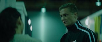 Movie still from “The Swimmers” (2022), directed by Sally El Hosaini – A person wearing a black jacket; Close Up shot, Over the shoulder angle