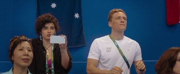 Movie still from “The Swimmers” (2022), directed by Sally El Hosaini – A man and a woman taking a picture with a cell phone; Medium shot, Over the shoulder angle