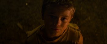Movie still from “Elysium” (2013), directed by Neill Blomkamp – A young man is looking into the camera; Close Up shot, High angle
