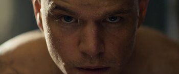 Movie still from “Elysium” (2013), directed by Neill Blomkamp – A man's face with water droplets on his face; Extreme Close Up shot, Low angle