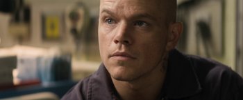 Movie still from “Elysium” (2013), directed by Neill Blomkamp – A person looking at the camera; Close Up shot, High angle