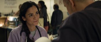 Movie still from “Elysium” (2013), directed by Neill Blomkamp – A woman in a purple lab coat talking to a man in a purple lab coat; Close Up shot, Over the shoulder angle