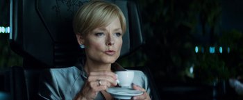Movie still from “Elysium” (2013), directed by Neill Blomkamp – A woman sitting in the back of a car drinking a cup of coffee; Close Up shot, Low angle