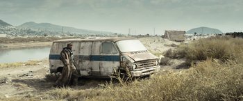 Movie still from “Elysium” (2013), directed by Neill Blomkamp – An old rusted van in the middle of a field; Wide shot, Low angle