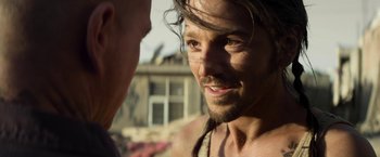 Movie still from “Elysium” (2013), directed by Neill Blomkamp – A person with long hair; Close Up shot, Over the shoulder angle