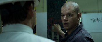 Movie still from “Elysium” (2013), directed by Neill Blomkamp – A man with a bald head looking in a mirror; Close Up shot, Over the shoulder angle