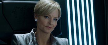 Movie still from “Elysium” (2013), directed by Neill Blomkamp – A person with short blonde hair; Close Up shot, Over the shoulder angle