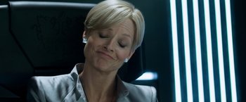 Movie still from “Elysium” (2013), directed by Neill Blomkamp – A woman sitting in a chair with her eyes closed; Close Up shot, High angle