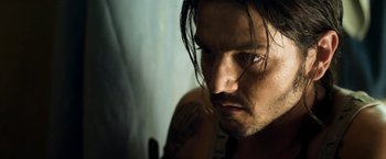 Movie still from “Elysium” (2013), directed by Neill Blomkamp – A person with tattoos on their face; Close Up shot, Low angle