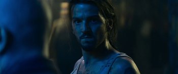 Movie still from “Elysium” (2013), directed by Neill Blomkamp – A person with blue paint on his face; Close Up shot, Over the shoulder angle