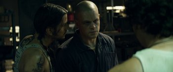 Movie still from “Elysium” (2013), directed by Neill Blomkamp – A man with a shaved head and a woman with long black hair; Close Up shot, Over the shoulder angle