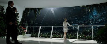 Movie still from “Elysium” (2013), directed by Neill Blomkamp – A woman in a white dress standing on a balcony at night; Wide shot, Low angle