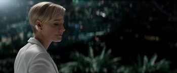 Movie still from “Elysium” (2013), directed by Neill Blomkamp – A woman standing in front of a city skyline at night; Close Up shot, Low angle