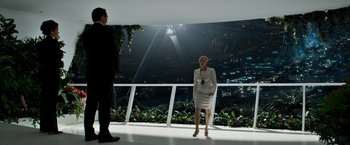 Movie still from “Elysium” (2013), directed by Neill Blomkamp – A woman and a man standing in front of a balcony; Wide shot, Over the shoulder angle