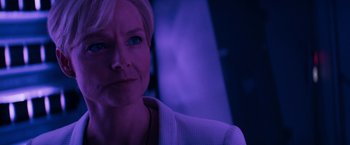 Movie still from “Elysium” (2013), directed by Neill Blomkamp – A person in a purple room; Close Up shot, Low angle