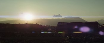 Movie still from “Elysium” (2013), directed by Neill Blomkamp – A plane is flying in the sky at sunset; Extreme Wide shot, Low angle