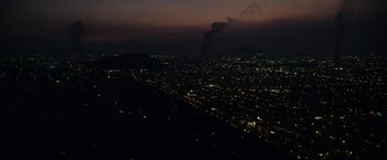 Movie still from “Elysium” (2013), directed by Neill Blomkamp – A view of a city at night from a hill; Extreme Wide shot, High angle