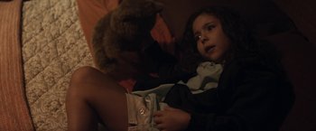 Movie still from “Elysium” (2013), directed by Neill Blomkamp – A girl laying in bed with a stuffed animal; Close Up shot, High angle