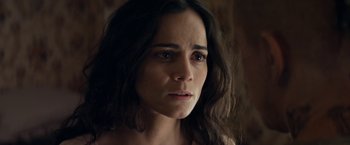 Movie still from “Elysium” (2013), directed by Neill Blomkamp – A person with long black hair; Close Up shot, High angle