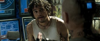 Movie still from “Elysium” (2013), directed by Neill Blomkamp – A man in a white tank top looking at himself in the mirror; Close Up shot, Over the shoulder angle