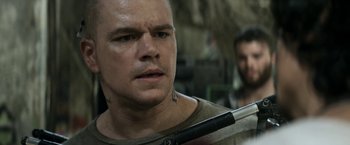 Movie still from “Elysium” (2013), directed by Neill Blomkamp – A man with a tattoo on his face holding a baseball bat; Close Up shot, Over the shoulder angle