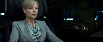 Movie still from “Elysium” (2013), directed by Neill Blomkamp – A woman sitting in the back seat of a car at night; Close Up shot, Over the shoulder angle