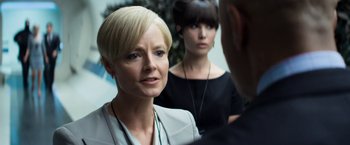 Movie still from “Elysium” (2013), directed by Neill Blomkamp – A woman with short blonde hair is looking at another woman; Close Up shot, Over the shoulder angle